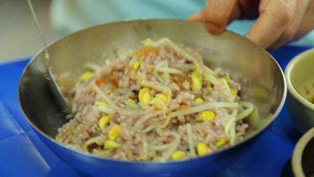 Bean sprout rice mixed with a spoon