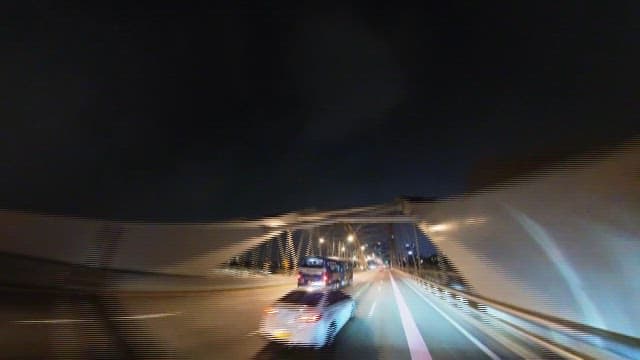 Bus and Vehicles Passing by on a Quiet Road at Night