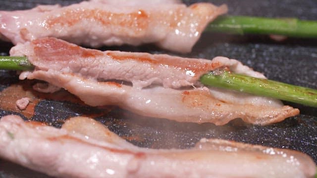 Thin-sliced Pork Belly and Asparagus Grilling on a Hot Pan