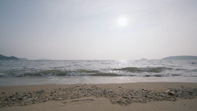 Serene Beach with Waves under the Strong Sunlight