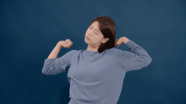 Long haired woman yawning with a tired and exhausted look
