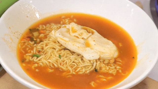Putting ramyeon with eggs in a bowl