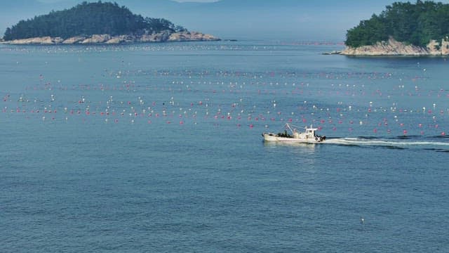 Fishing boat sailing near coastal islands