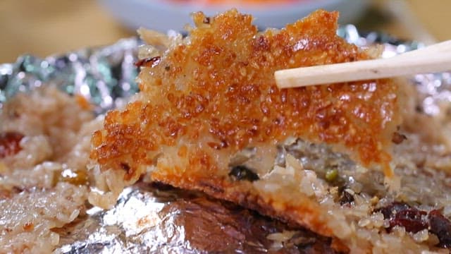 Crispy nurungji being lifted with chopsticks