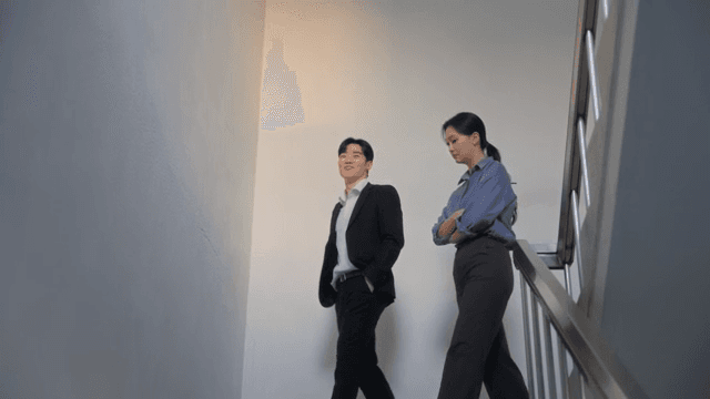 Two people talking in a stairwell
