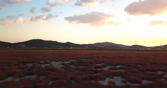 Sunset over a serene landscape with hills