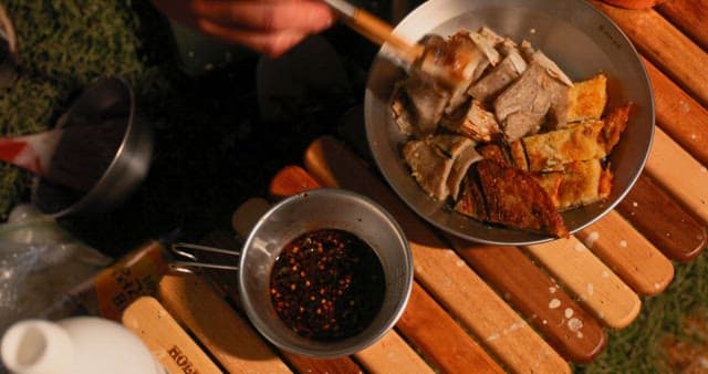 An evening meal outdoors with savory dishes