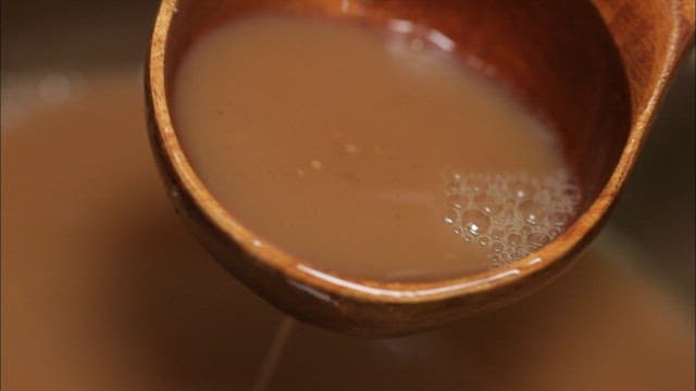 Dark golgamju poured into a traditional jar