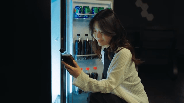 Person Choosing Beverage from Fridge at Night