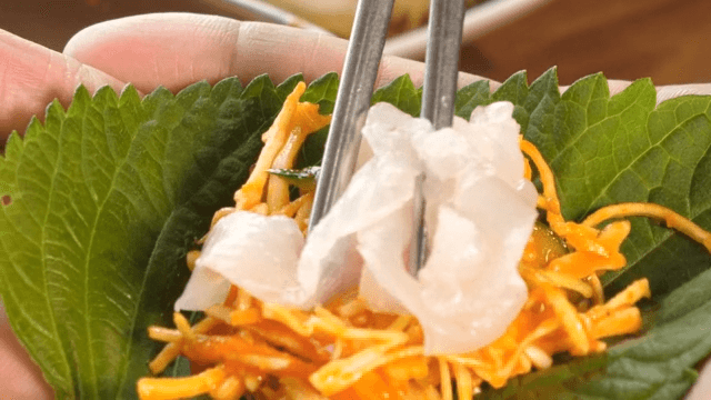 Fresh raw fish and vegetable salad wrapped in perilla leaves