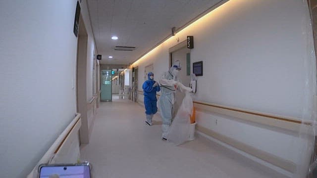 Hospital Hallway with Medical Staffs WearingSuits for Quarantine