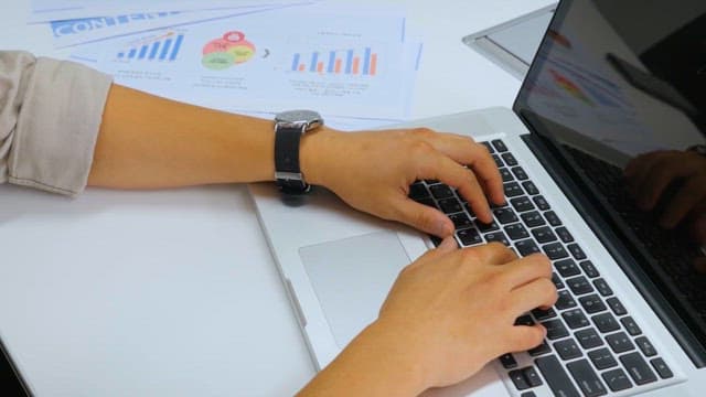 Professional Working on Laptop with Business Data