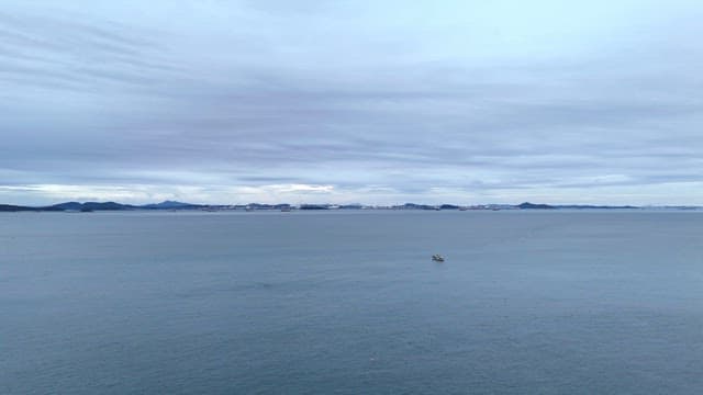 Calm sea with distant mountains