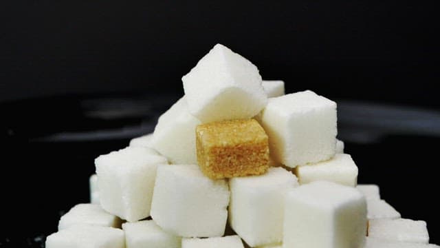 Honey poured over piled sugar cubes