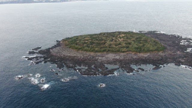 Remote island surrounded by blue sea on a sunny day