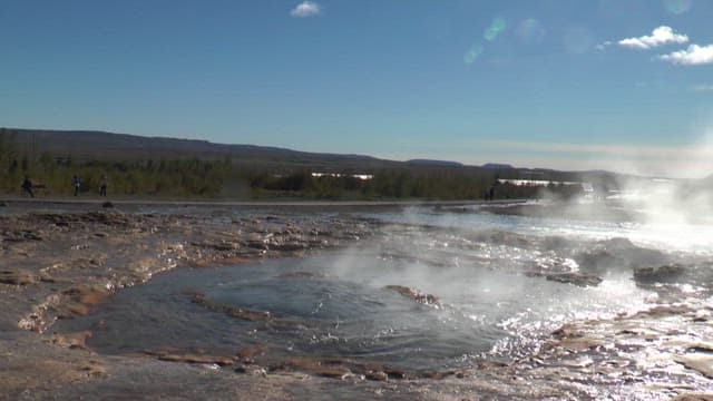 Geyser Eruption in Geothermal Field on a Sunny Day