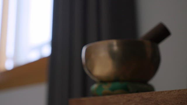 Singing bowl on a table by the window