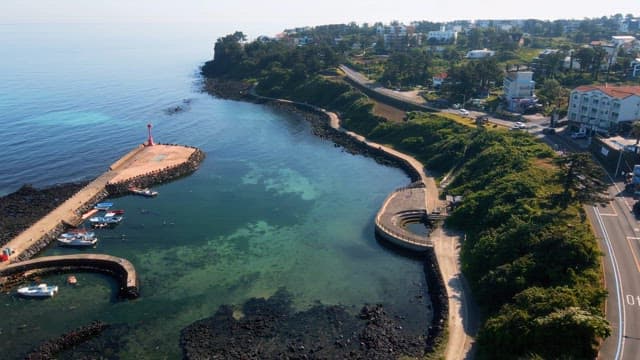 Coastal view with a lighthouse and boats