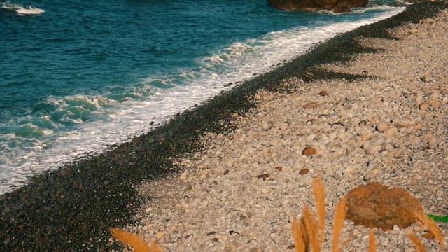 Waves Crashing on a Rocky Pebble Beach