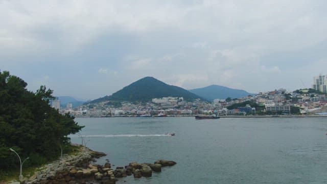 Coastal city with mountains in the background