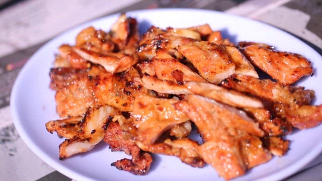 Grilled marinated pork ribs on a white plate