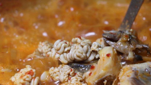 Delicious spicy stew with fresh fish and instetines