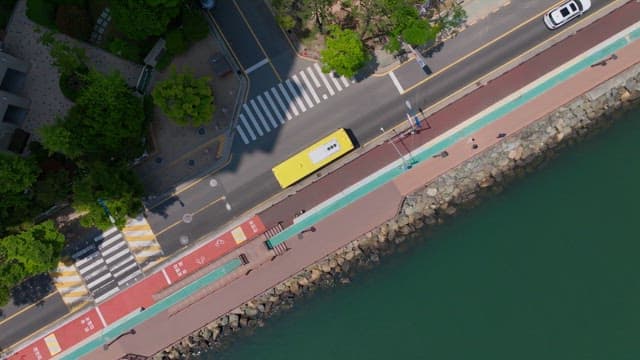 Coastal road view with pedestrians and vehicles