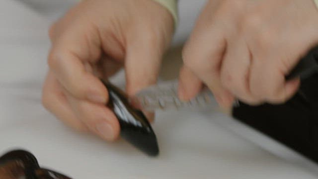Opening mussels with a knife on a cutting board