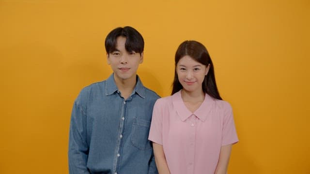 Man and a woman smiling affectionately while looking straight ahead