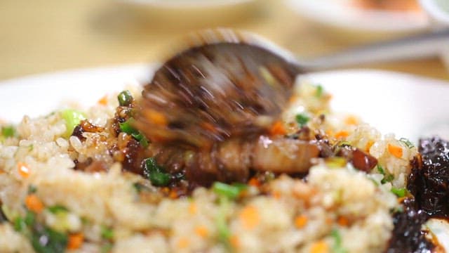 Spoonful of fried rice with vegetables and Jjajang sauce