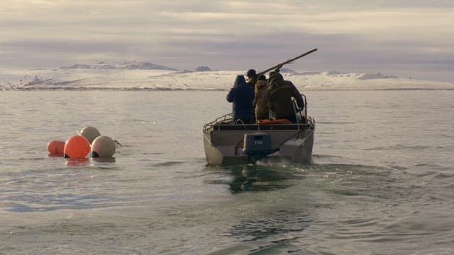 People Hunting by Throwing Harpoons From a Boat