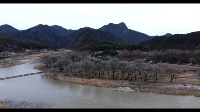 Peaceful river landscape surrounded by mountains and trees
