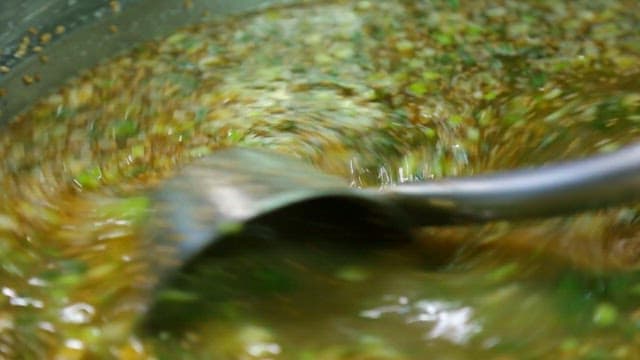 Stirring a flavorful herb-infused sauce