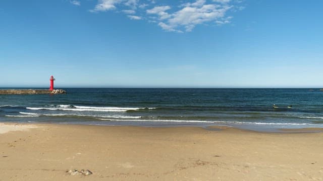 Serene Beachscape with Red Lighthouse