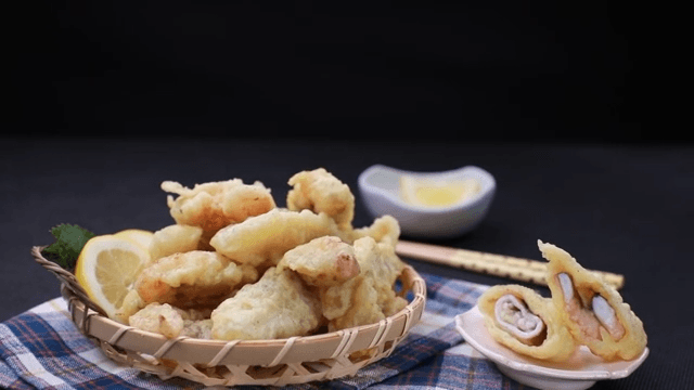Basket of fried webfoot octopus with lemon slices