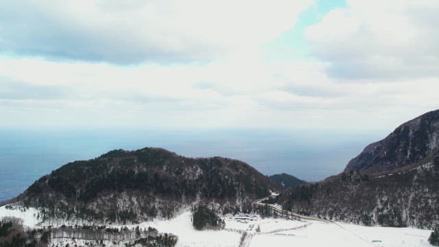 Blue Sky and Sea Beyond the Snow-Capped Mountains