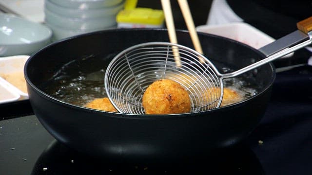 Crispy croquettes lifted from the oil