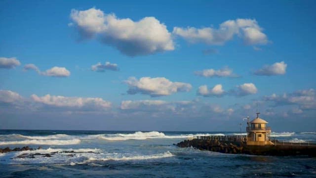 Waves Crashing Near Coastal Watchtower
