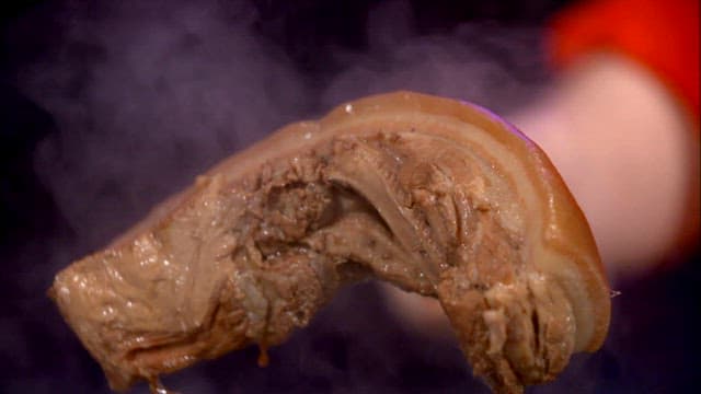 Lifting steamy boiled pork slices