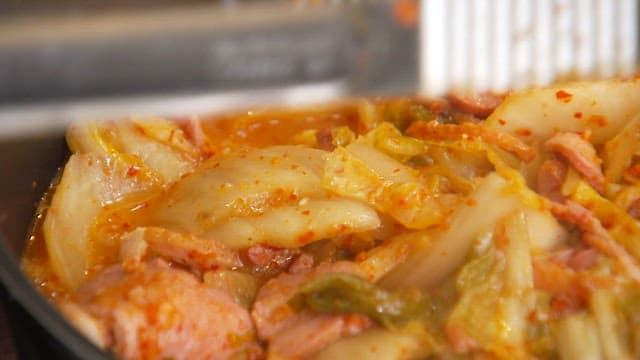 Cooking spicy kimchi stew with smoked duck