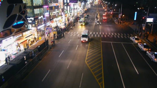 Ambulance running through a busy city at night