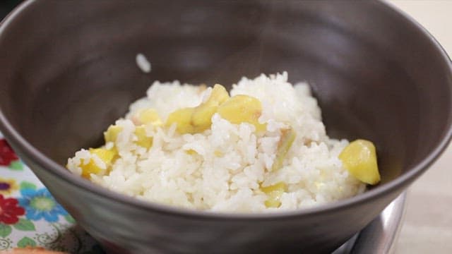Steaming bowl of chestnut rice and chive soy sauce