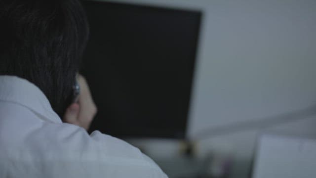 Man who answered the phone is hurriedly walking down the hallway