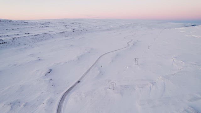 Sunset snowy landscape with winding road