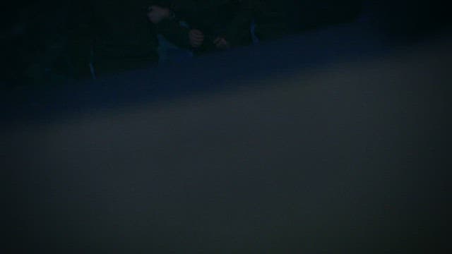 Arrested Man Being Taken on Dark street