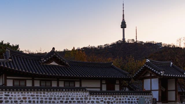 Traditional Korean houses with tower at dusk