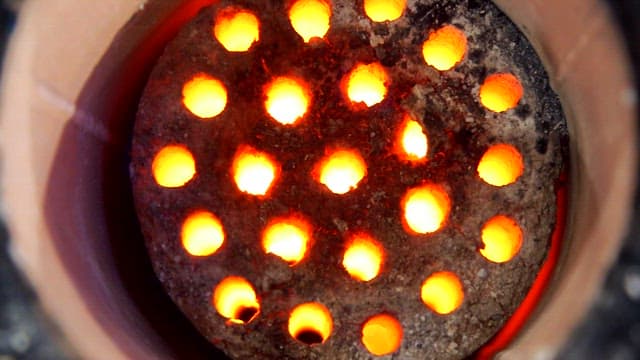 Glowing charcoal briquettes in a stove