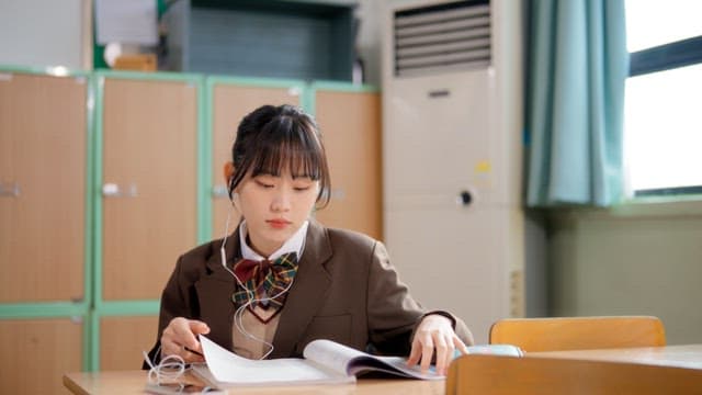 Students studying and sharing earphones