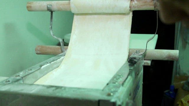 Noodle dough being processed in a machine