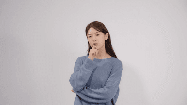 Woman lost in thought, resting her finger on her chin